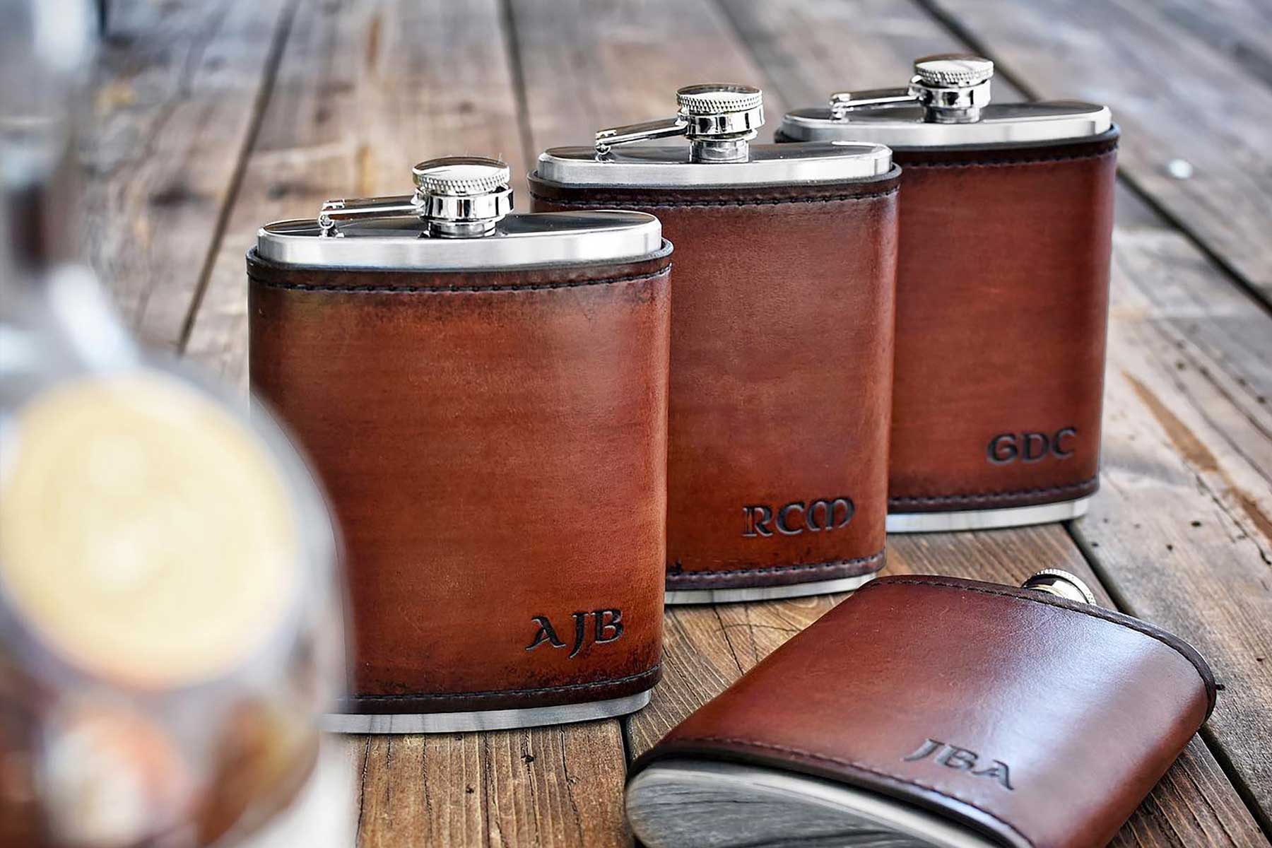 Leather wrapped flasks personalized with hand stamp initials. An excellent choice for your groomsmen gift, father's day, birthday, graduation, or any of life's special moments.