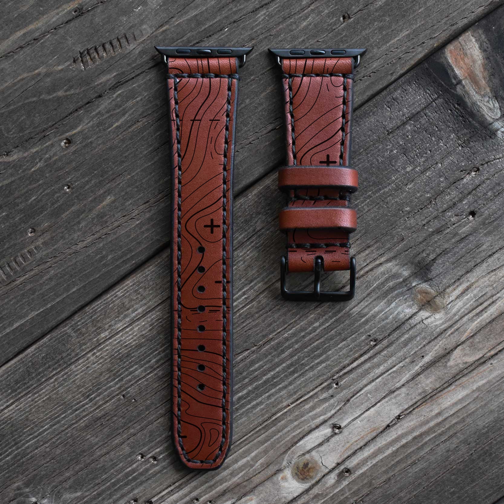 Blackthorn leather brown watch strap on an Apple Watch Ultra with engraved topographic map pattern.